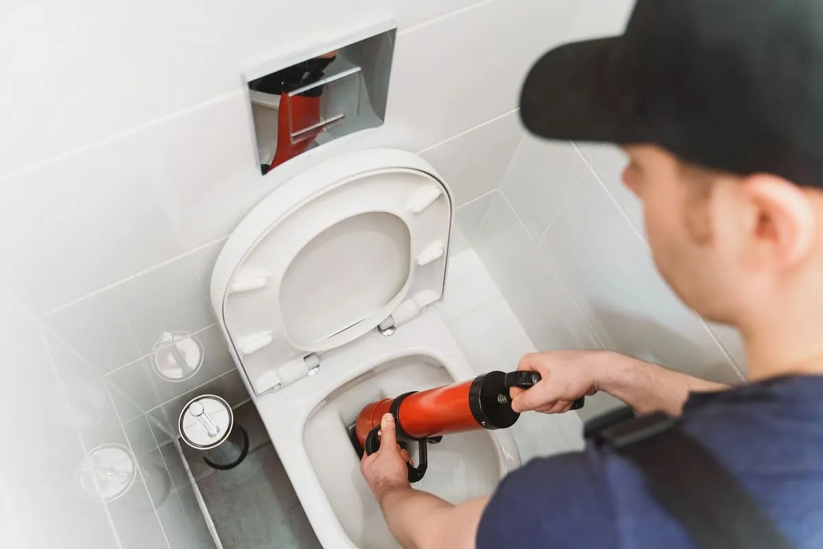 Expert plumber fixing a toilet in Quinte West